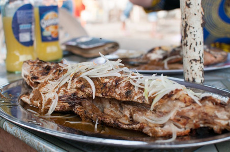 Enjoying grilled fish in Limbe, Cameroon Limbe